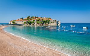 Sveti Stefan historical town island and paradise sand beach. Budva Montenegro. e1649053627921